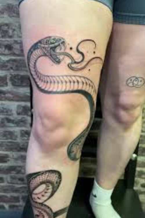 dagger and snake tattoo in legs