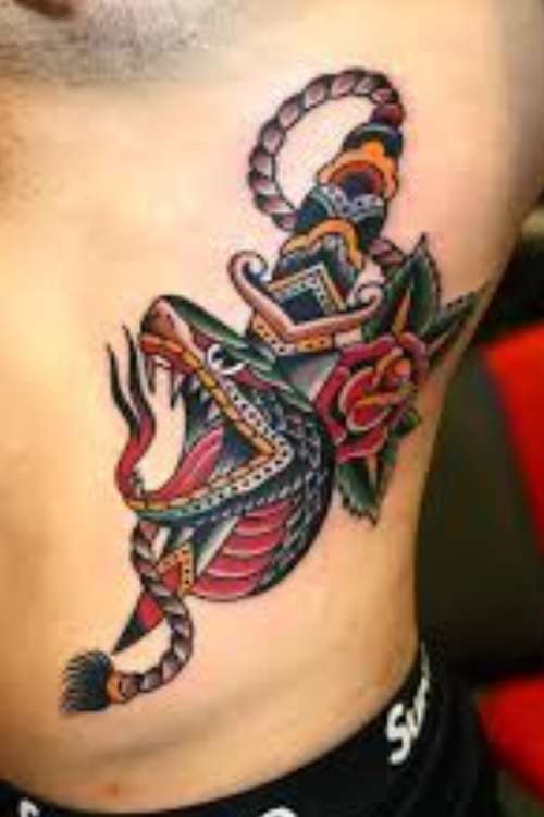 dagger and snake tattoo in ribs