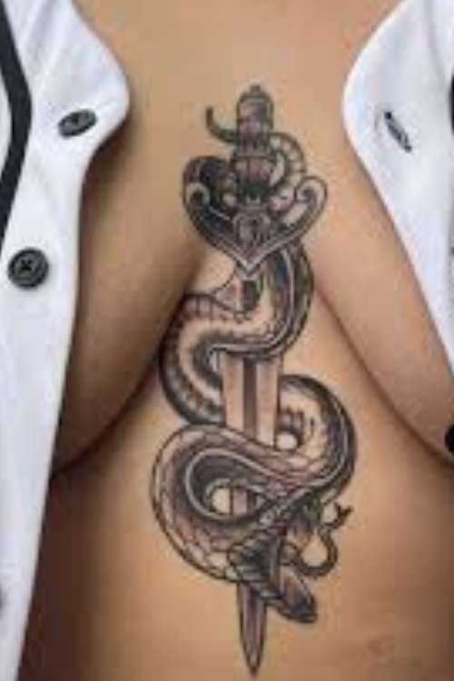 dagger and snake tattoo in chest
